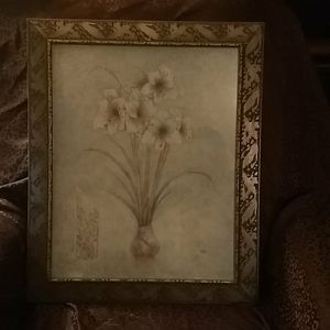 Framed picture of flowers in a vase.